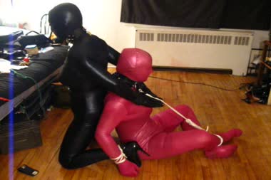 Double Bound - Bianca and vanessa are bound together back to back while wearing lycra zentai suits