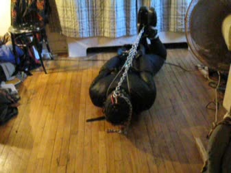 Restrictive Ball Tie  Restrictive Hog Tie - Vanessa fetish is bound first in a ball tie, locked into chains, gagged and bound, then into a hogtie, where she is not only chained into a hogtie, but her hood is as well! She squirms as the vibrator brings her to a moaning climax!