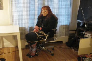 Shemale Secretary Chair Bound - Vanessa is bound to an office chair wearing business suit, and gagged with a bit gag