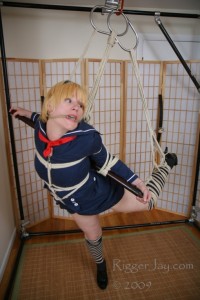 Japanese Schoolgirl Shibari Suspension Pt 1 - Japanese schoolgirl suspension part 1 -
sailor suit suspension

i had an opportunity to visit an old friend in boston last summer.

though we met in a completely vanilla context long before we came out of the closet, we quickly discovered one anothers kinky side through casual conversational innuendo. It is amazing how easily you let things slip after a few drinks in las vegas! That shared kinky chemistry has sparked a decade-long friendship and a series of naughty adventures across the country!

when we met long ago, it was at retail industry trade shows. Rigger jay has now gone on to blossom into a world-famous japanese-style rope bondage artist.

when he invited me to come to the east coast to help teach his rope bondage 101 classes, I couldnt resist the opportunity to hop on a plane and cause some mischief even though I knew that *i* would be the one in bondage this time!

my love of bondage is shaped from both sides of the rope and the cameras lens. It is my passion to delve ever deeper down this kinky rabbit hole and there is nothing like the seductive art of japanese bondage (as my teacher diva midori  memorably phrased it).

since rigger jay is a shibari master, this shoot immediately took on a japanese flair. I am wearing a sailor suit, torn open to reveal my perky breasts and raspberry nipples with a matching ultra-short skirt revealing my nearly see-through white panties. The little pink hearts on these lacy underpants are almost too embarrassingly cute to share!

my anime-style schoolgirl uniform is the real thing from overseas, imported by hand and at great expense by a fellow kinkster there for a business convention. What is it about vanilla tradeshows that brings out mens kinks and perversions? Is it because you are away from home and prying eyes, looking for trouble? Is that what unleashes all this lust?  When youre out of town, it is harder to get caught!

ive often worn this costume to anime conventions and turned heads everywhere I went but I think this shoot is the real reason we went to so much trouble to import a real japanese schoolgirl uniform to the united states!

i couldnt wait to get into rope bondage and bamboo restraints dressed like this, and my enthusiasm shows. I asked him specifically to gag me for this video because it also gives me a chance to enjoy the unique flavor and texture of his lovingly conditioned hemp rope. Cotton pales in comparison to the bite, texture, scent and quality that you get with real hemp, but it requires successive washing, softening and oiling before it is fit for sexy submissive skin.

my favorite part of being in bondage is wearing a gag of some kind. I know that I am notoriously noisy when aroused and I take comfort in being muffled. That gives me the permission I need to unleash my moans and screams in relative safety. I love bondage even more if there is something in my mouth!

this is a partial suspension in the japanese style, with one leg up asymmetrically and my arms bound tightly against a bamboo rod. I struggle, grab at the ropes and dangle for your amusement. There are plenty of full suspension moments in this shoot, as I lift myself fully off the ground in my desperate effort to find a weak point in my bindings.

im helpless to hide my arousal as I spin in place, struggling.

because, you see, rigger jay and I have a bet going and if I cant get out of these ropes, then we move on to stage 2: ****** orgasms!

you can find more of rigger jays bondage, photos and art at his website: http://****riggeryjay****

you can enjoy more of my videos, photos, stories and blog at ****aliceinbondageland****