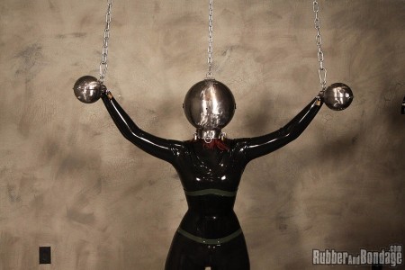 Head Bangers Ball - The combination of heavy metal and rubber really seems like an odd pairing on paper. In reality, metal is such an awesome raw material to utilize in the creation of any bondage device. I do not know what it is about this particular set of metal head and hand balls we had custom made for the rubber and bondage studio but they amplify my desire to do bad things to women. I don't know if it is about the dehumanizing nature it creates for the women trapped inside. Maybe it is just the overall *********** experience generated for the submissive women we pair the device with. It could be that I just like taking things away from women in as bizarre a manner as possible. In any case, miss k was the latest latex clad ****** to serve time locked inside these spheres. Once positioned properly, the balls were locked onto her head and hands. Chains were connected to each metal hand ball which ****** her arms up, out and wide. Another chain was affixed to the top of the head ball to support the weight of the metal. 

since miss k was going to be busy coping with sensory overload and deprivation at the same time, we figured she did not need to be trying to keep her head from flopping over or off. There is also the issue of the one tiny hole in the front of the head ball that allows for limited air in an out. This would serve to further increase miss k's heart rate and potential for panic. The more distressed the submissive the better in my opinion. Once miss k was strung up and ready to be rocked, our guest controller "fk" stepped in while fully clad in rubber, head to toe. He used to be in a band I am told so he strummed some notes on miss k's clit with real expertise. He uses a vibrating magic wand while trying to get her pussy in tune. Eventually fk started playing tease and denial which is one of our all-time favorites. Near the grand finale of our head bangers ball, miss k is ****** to cum, rocked and rolled into the orgasm hall of fame. For those about to get their clit rocked, we salute you.